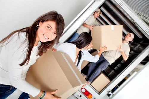 Furniture and boxes being loaded into a moving van